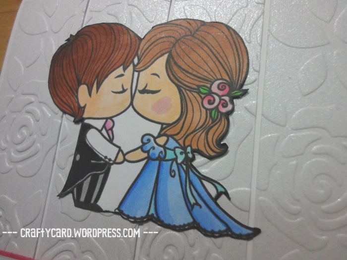 A closer look at the copic colouring of the lovely couple with the rose embossed background. 